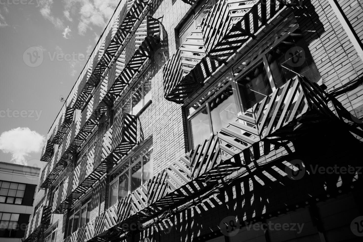 View of the facade of a black and white building with balconies. City. The steel facade of a residential building in the city. photo