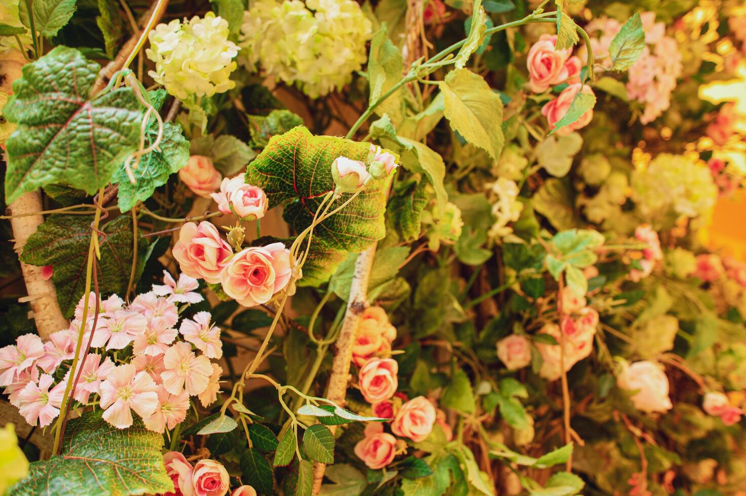 Beautiful floral background on the wall with different flowers, roses and a floral bouquet. Vintage banner made of flowers and leaves. photo