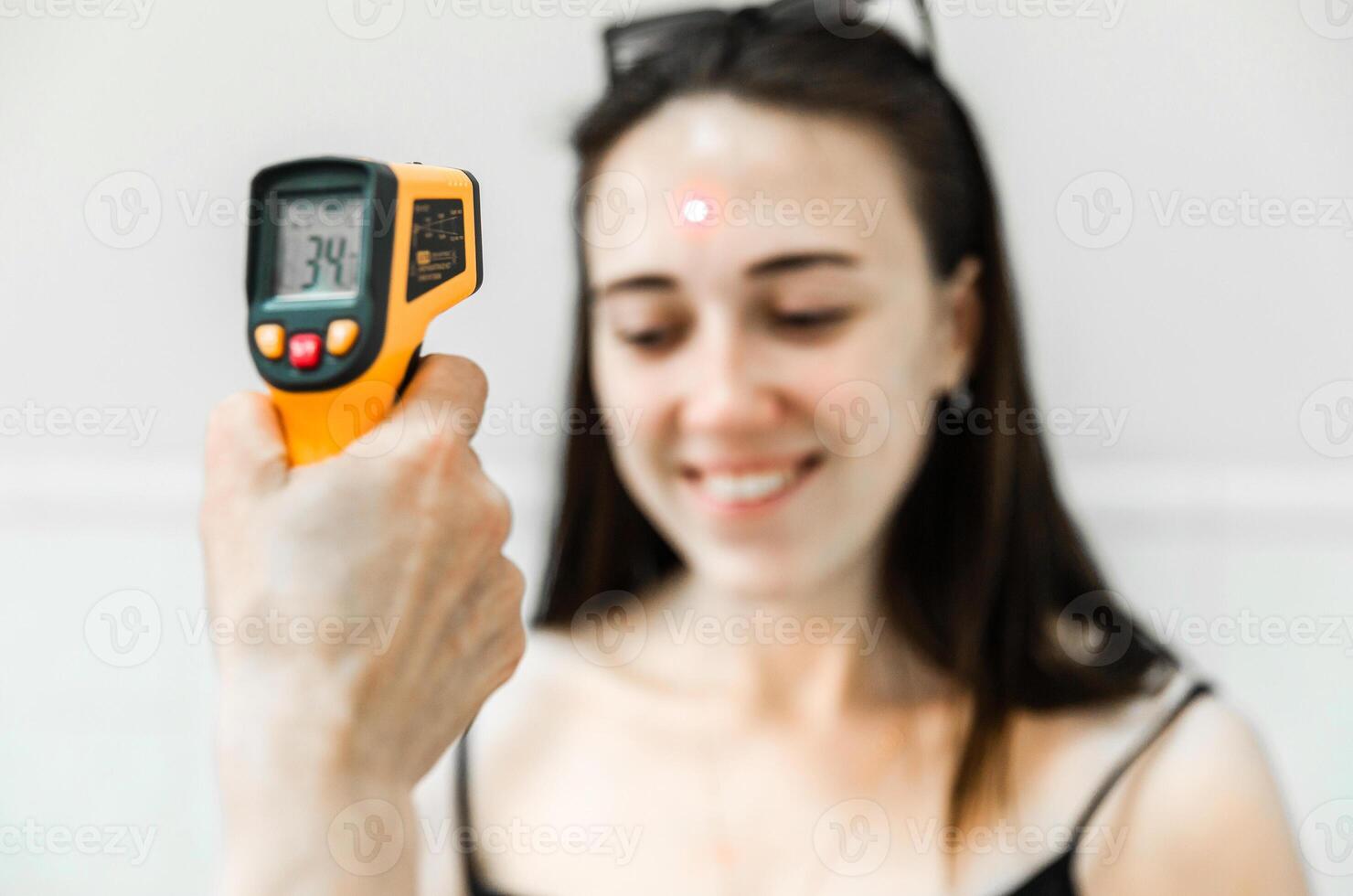 Infrared Thermometer Checking Forehead Temperature photo