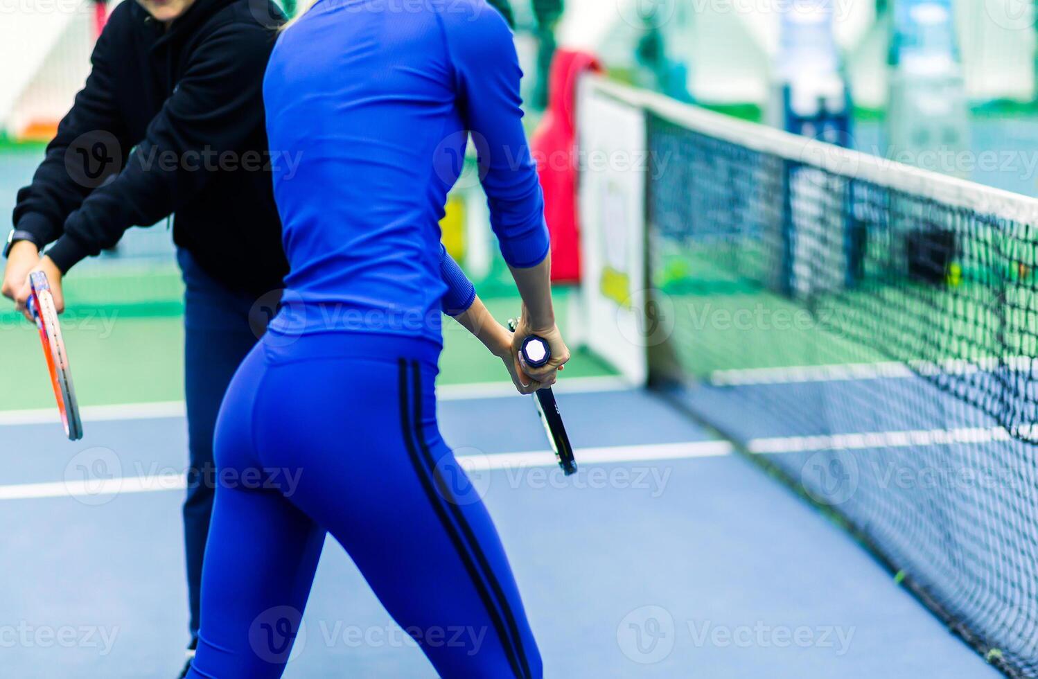 Tennis Coach Training Woman on Court photo