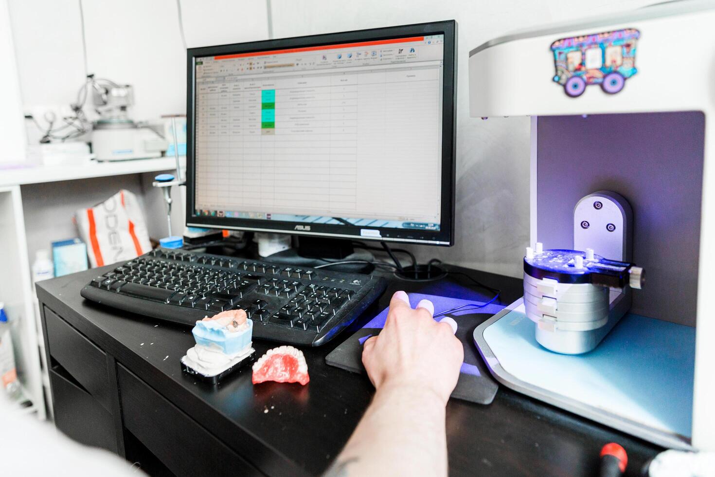 Dental technician working on dental records. Minsk, Belarus- October 15, 2023 photo