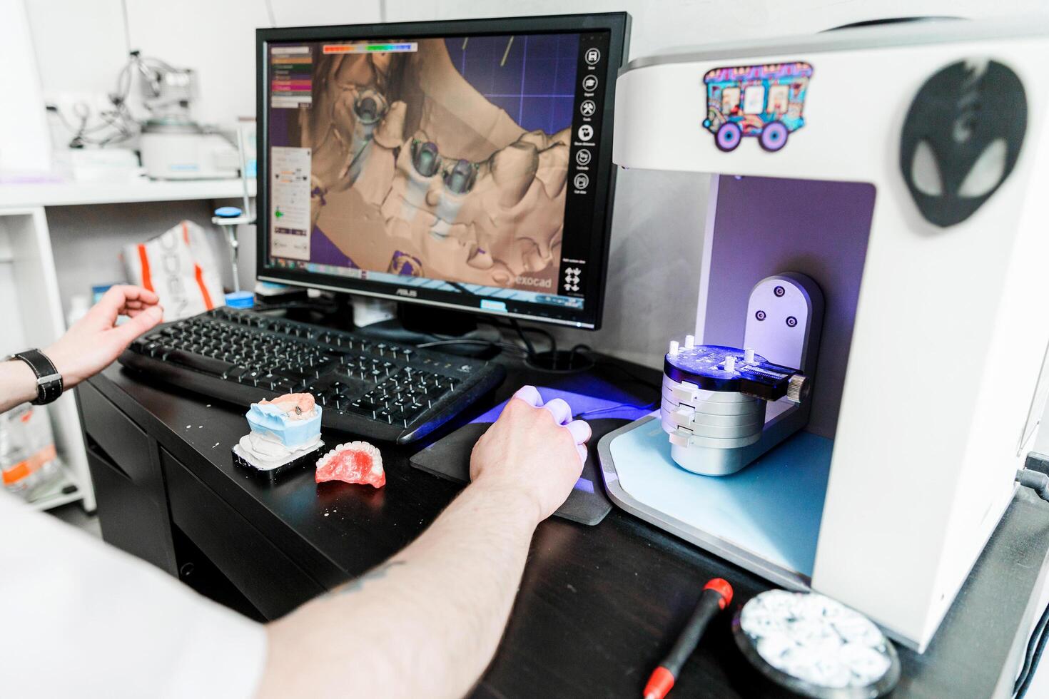 Dental technician working on a computer. Minsk, Belarus- October 15, 2023 photo