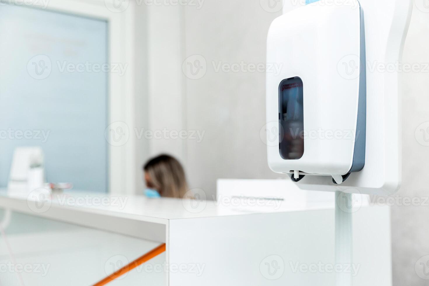 Reception Desk with Hand Sanitizer Dispenser in Clinic photo