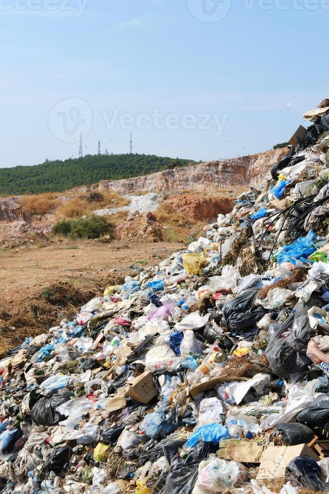 Garbage Dump Site with Green Trees and Antennas Distant photo