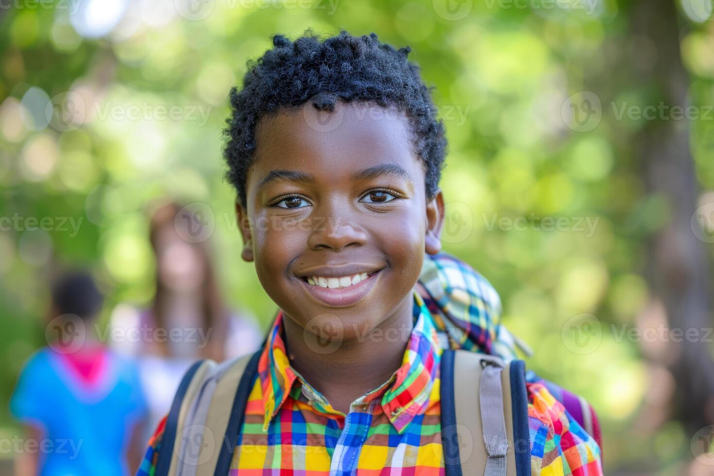 Portrait smiling Afro American school boy short curly hair, wearing backpack, blurred background back to school photo
