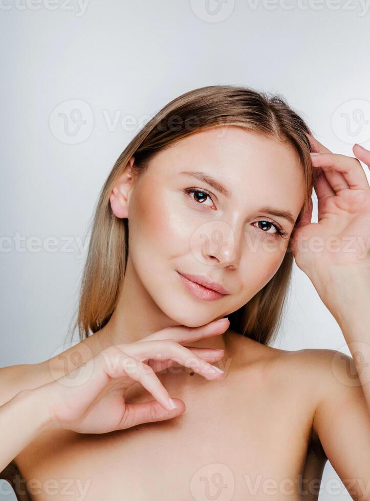 Young Woman with Beautiful Skin Touching Face photo
