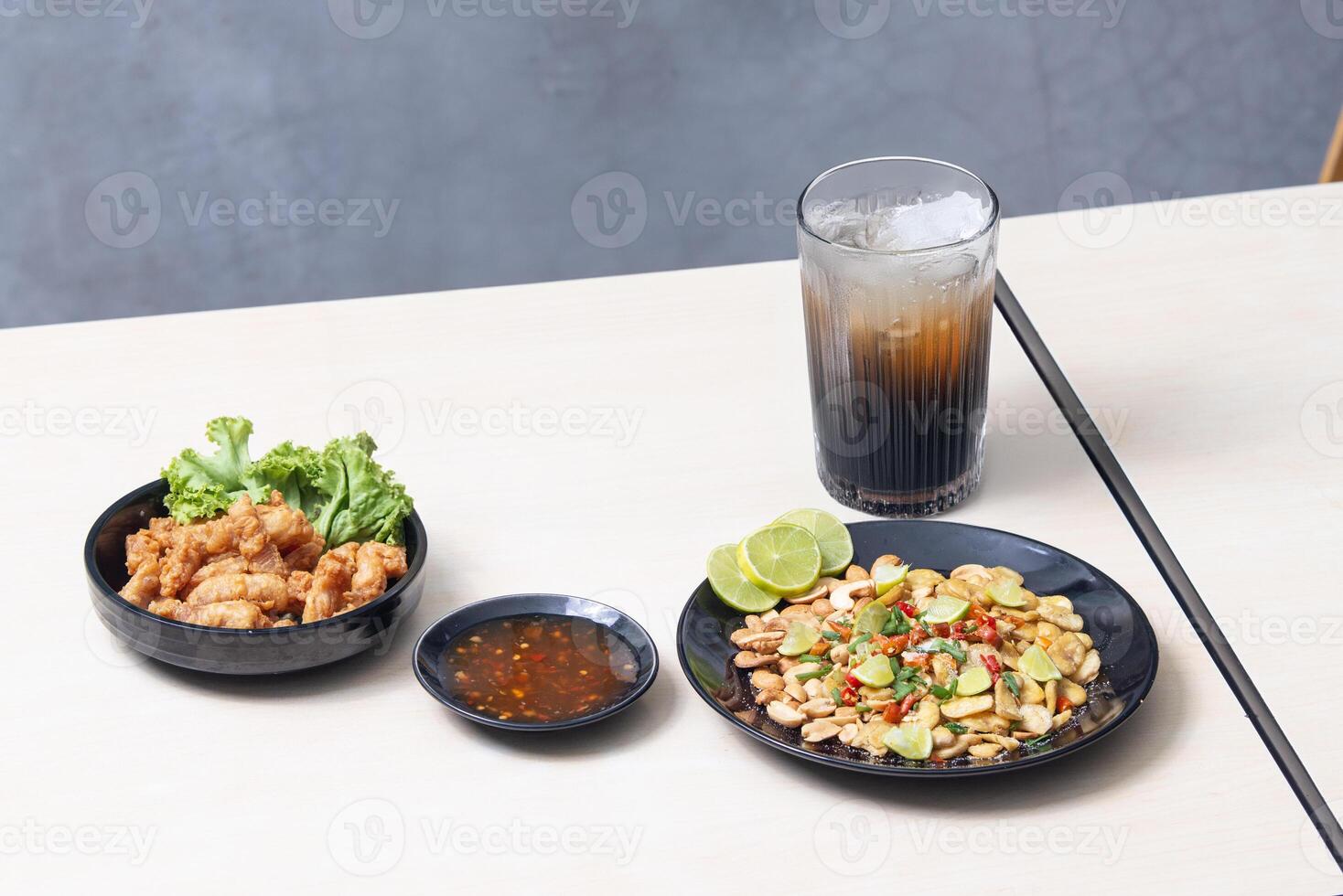 Popular snacks in the restaurant at Thailand. Peanut with salt, Crisp rice, Deep fried chicken tendons. photo