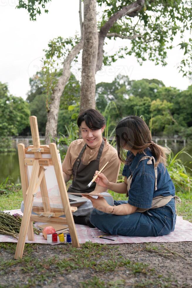 Romantic Picnic Couple Drawing Outdoors in Nature with Easel and Painting, Capturing Creative Moments in a Serene Park Setting photo