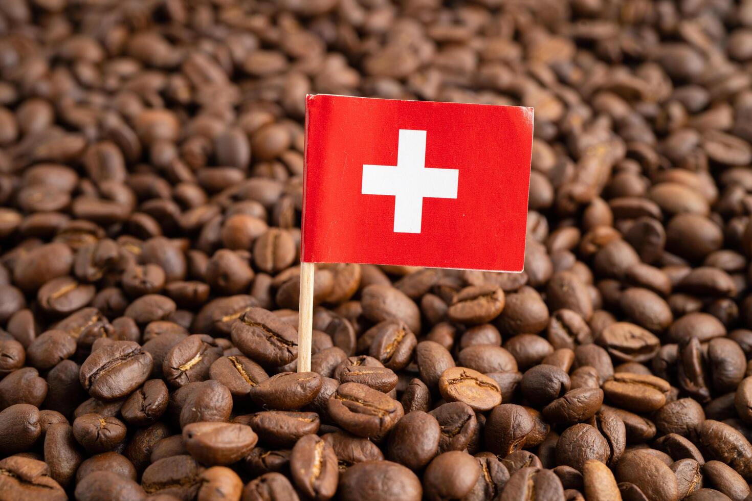 Switzerland flag on coffee bean, import export trade online commerce. photo