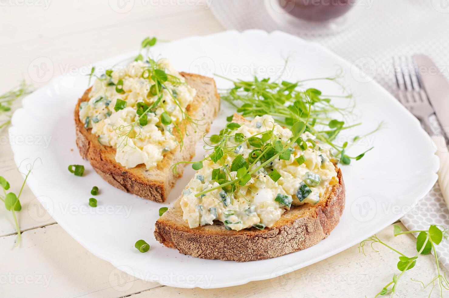 Delicious toast with pate boiled egg, cucumber and cream cheese on a white plate. Healthy eating, breakfast. Keto diet food. Tasty food. photo