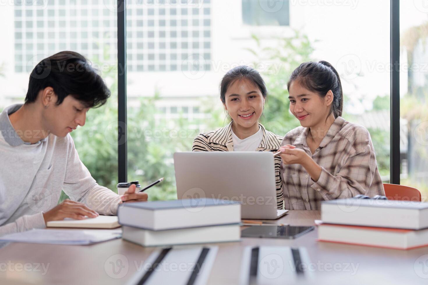 Group of Student Studying Together with Laptops and Books in a Modern Classroom Setting photo
