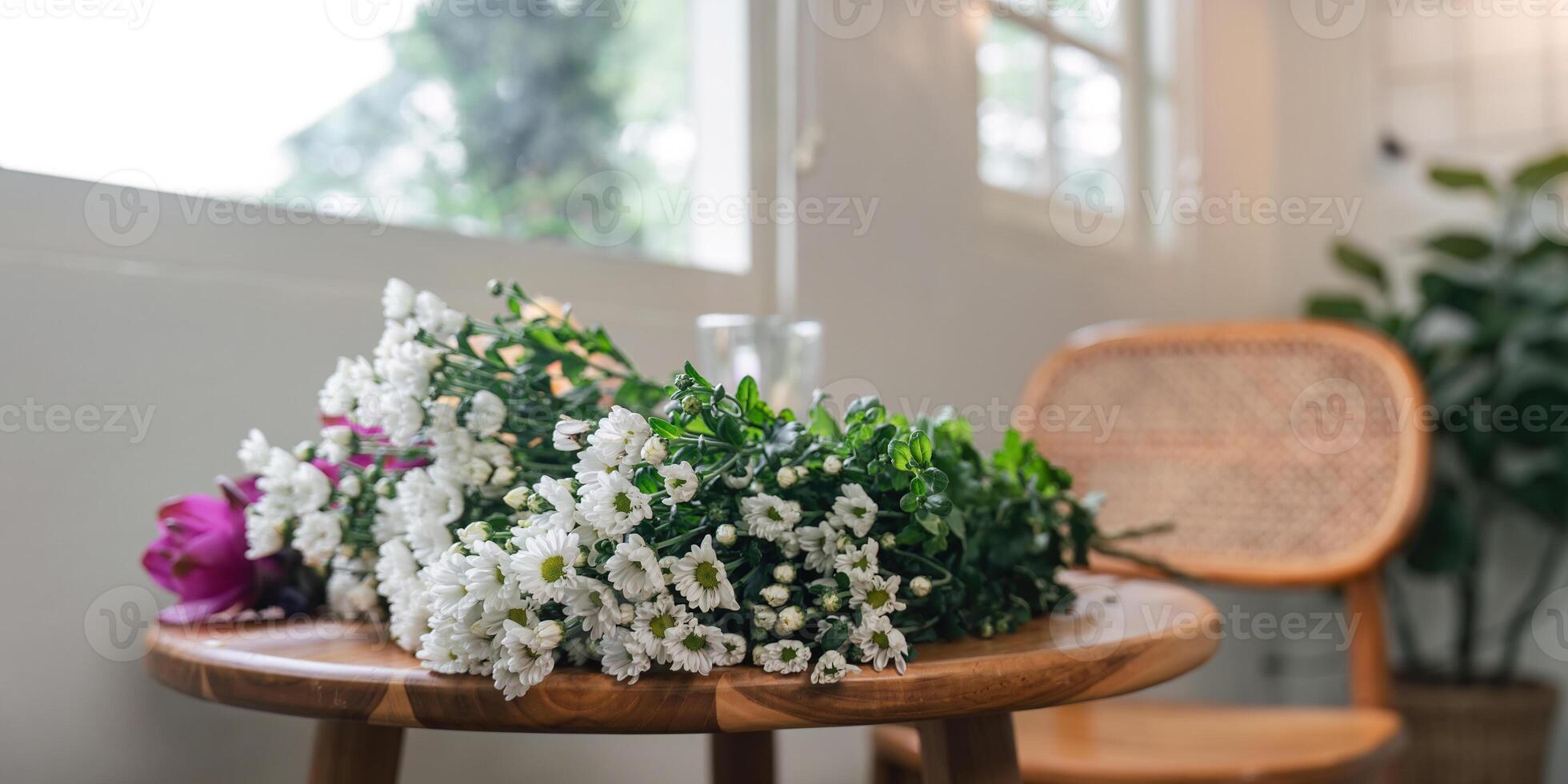 Beautiful Flower Arrangement on Wooden Table in Cozy Home Interior with Natural Light and Rattan Chair photo
