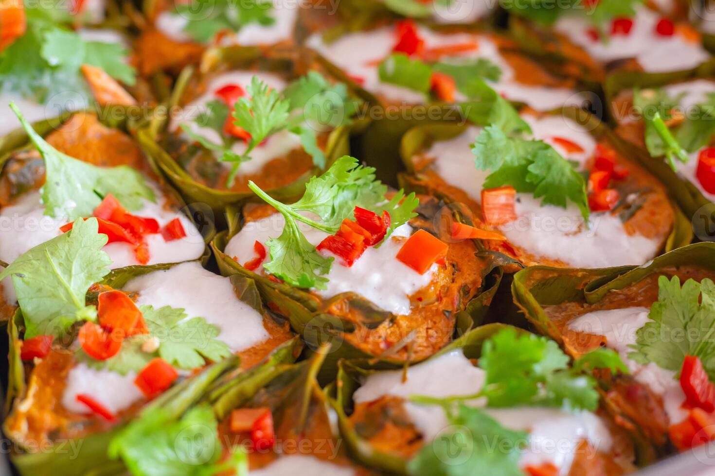 Steamed Fish with Curry Paste Ho Mok It is a spicy and delicious Thai food consisting of curry paste made from chili peppers and herbs fish fillets vegetables and coconut milk seasoned with fish sauce photo