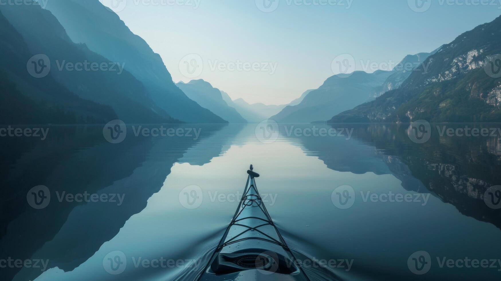 A kayak is in the water with mountains in the background photo