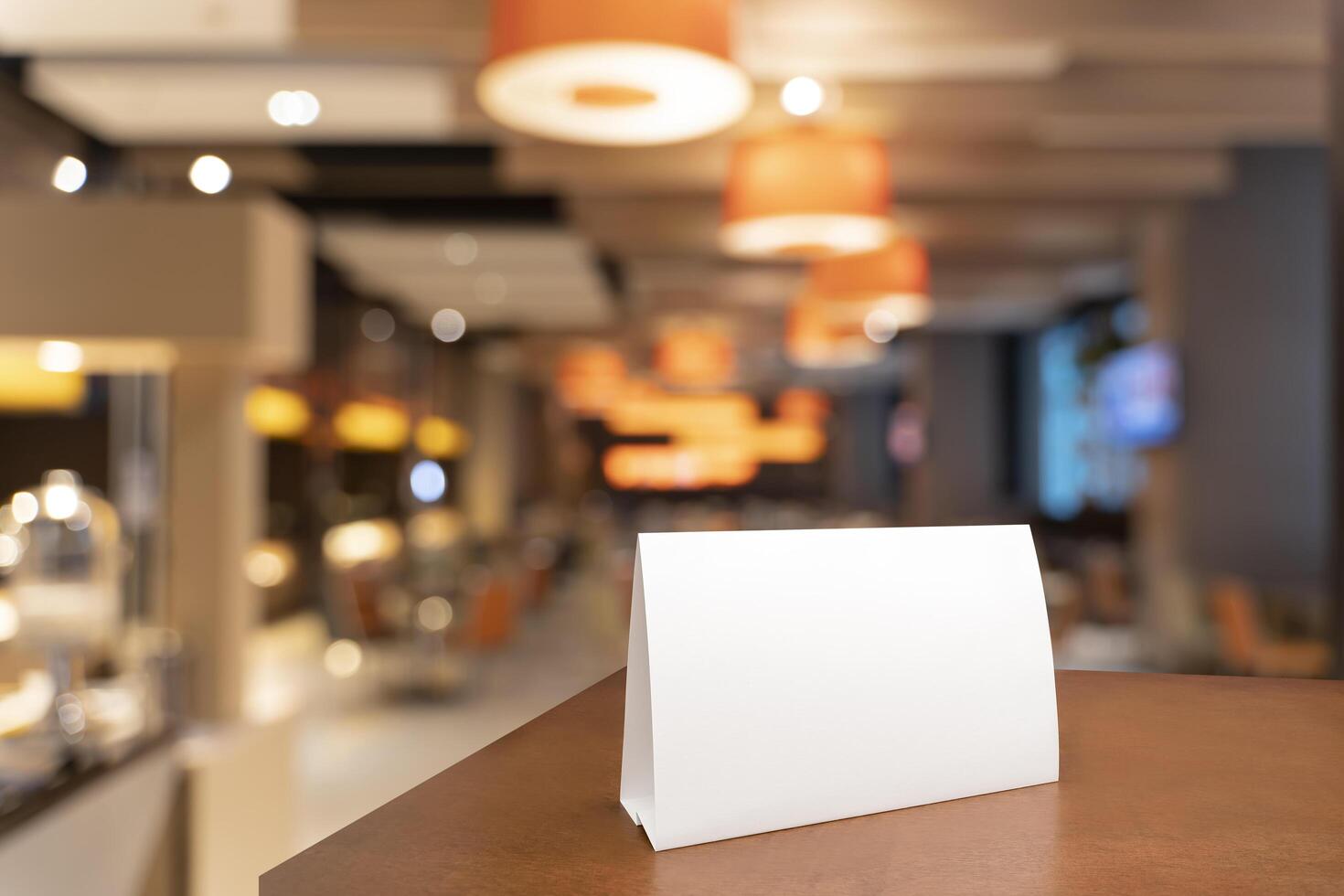 Blank menu frame label mockup in restaurant bar stand for booklet with acrylic white sheet paper tent card on wooden table photo