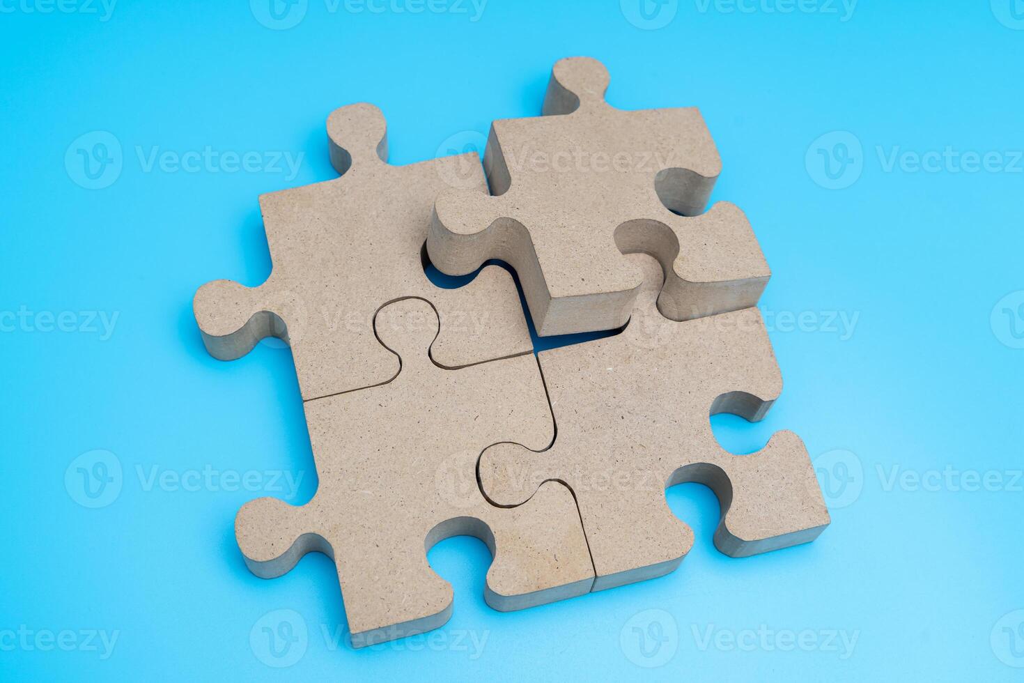 Top view. wooden Jigsaw Puzzle parts on blue background. four puzzles form a rectangle photo