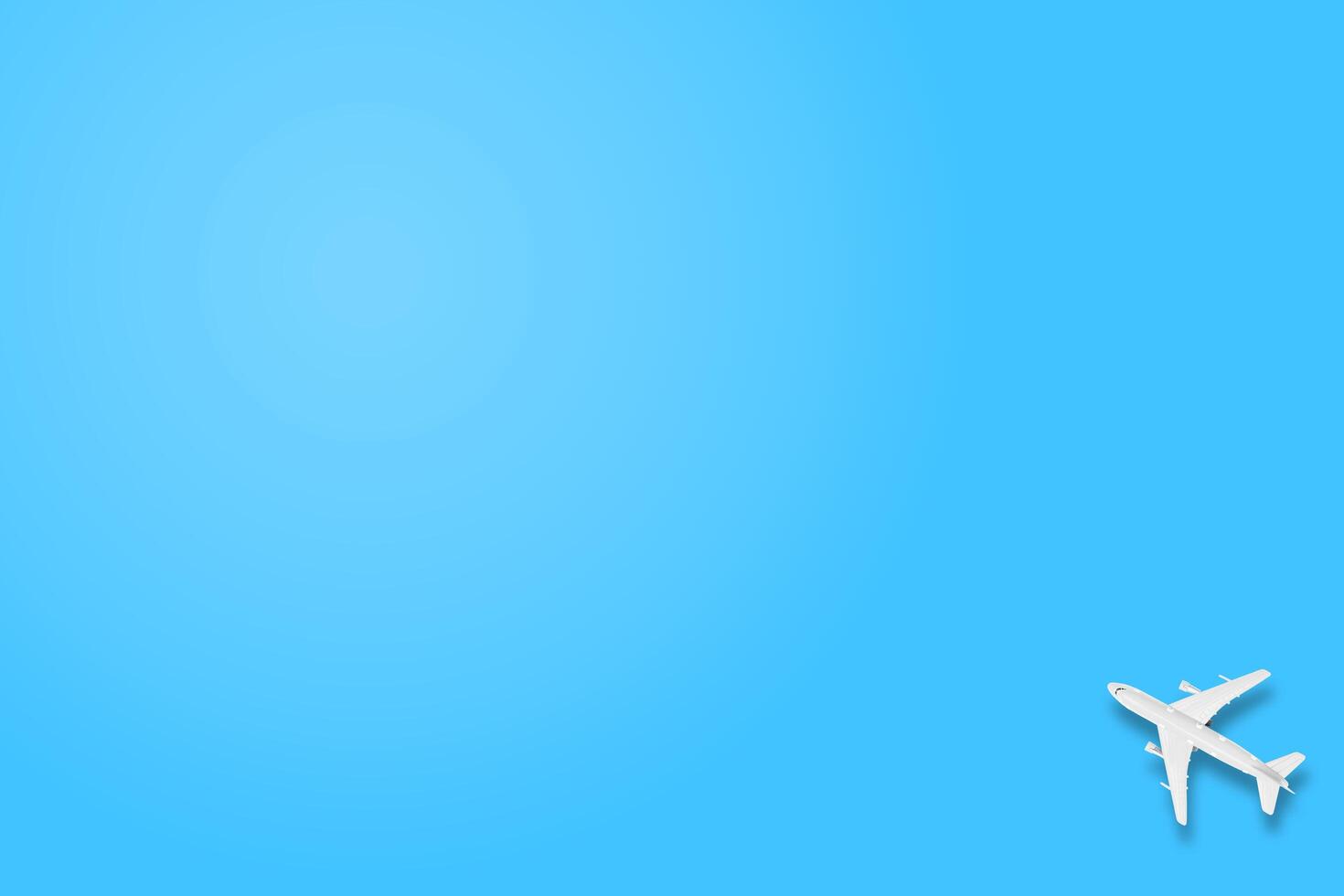 Travel flat lay composition airplane on blue background with copy space, transportation concept. photo