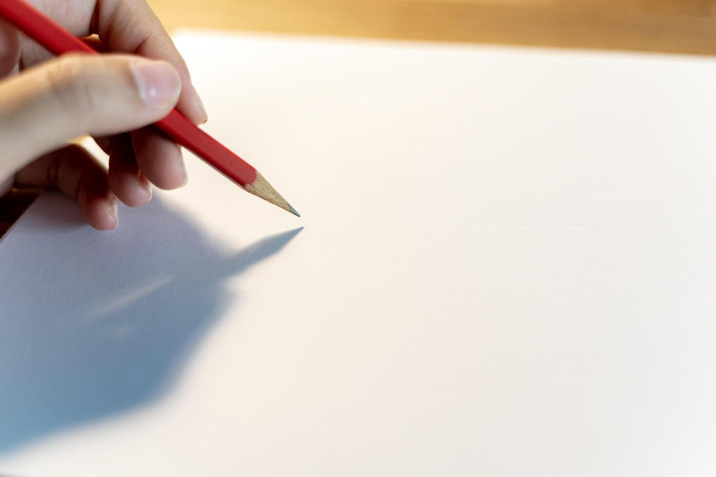 Close up business women hand is writing notebook with laptop at home, left handed women writes photo