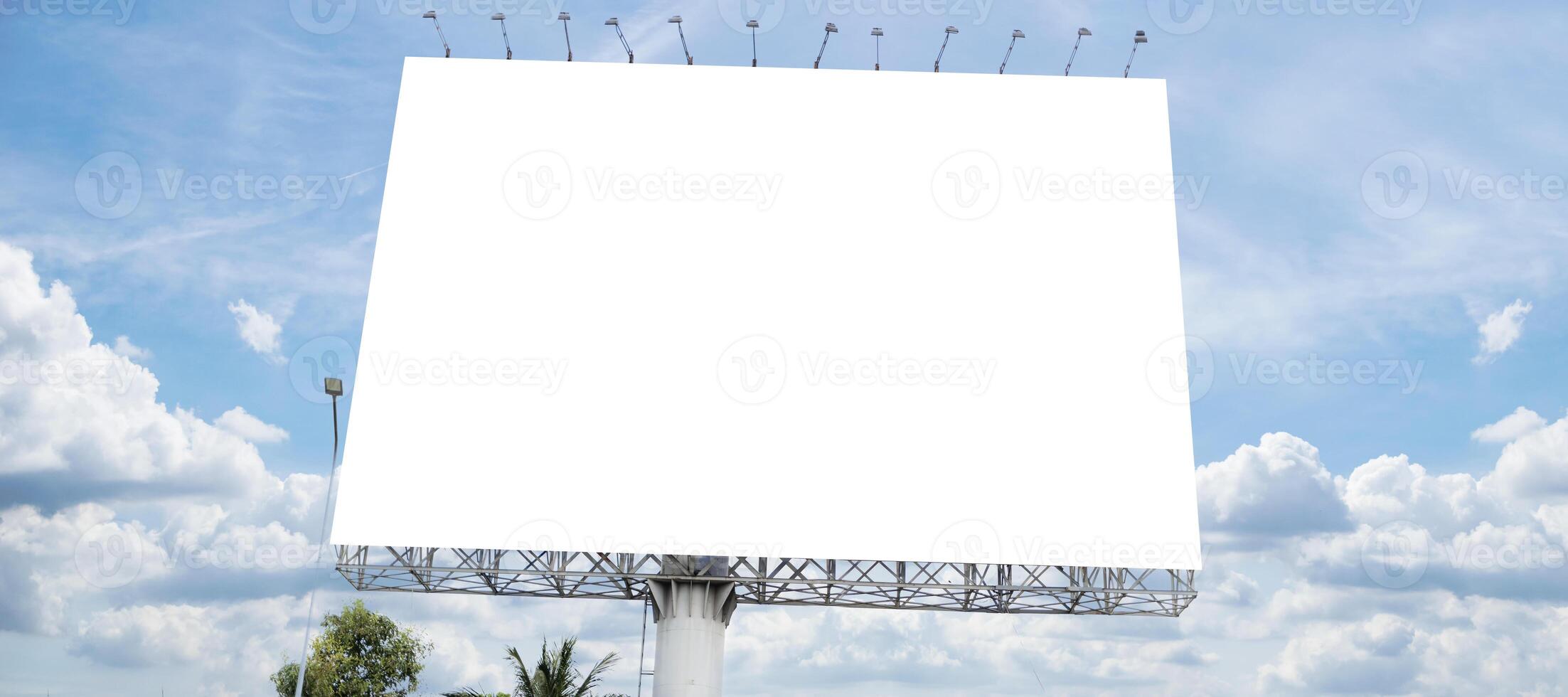 Blank white billboard with room to add your own text, background with white clouds and blue sky for outdoor advertising, banner photo