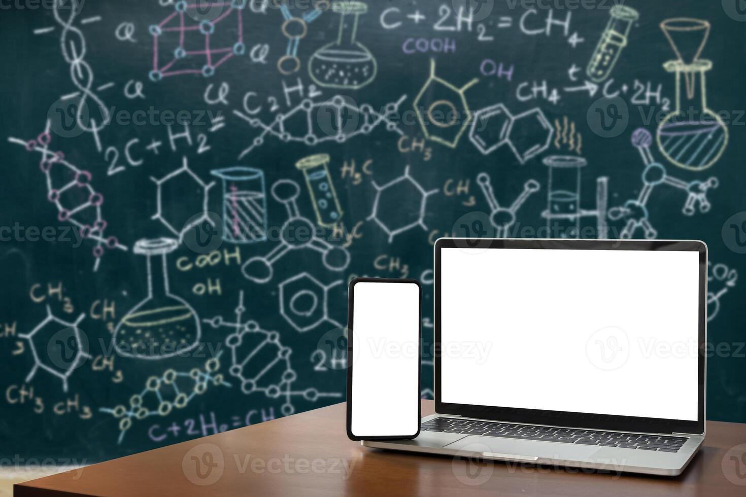 Laptop, smartphone, blank screen lies on wooden table for foreground. Molecule models and formulas Organic chemical formulas biochemistry scientific background photo