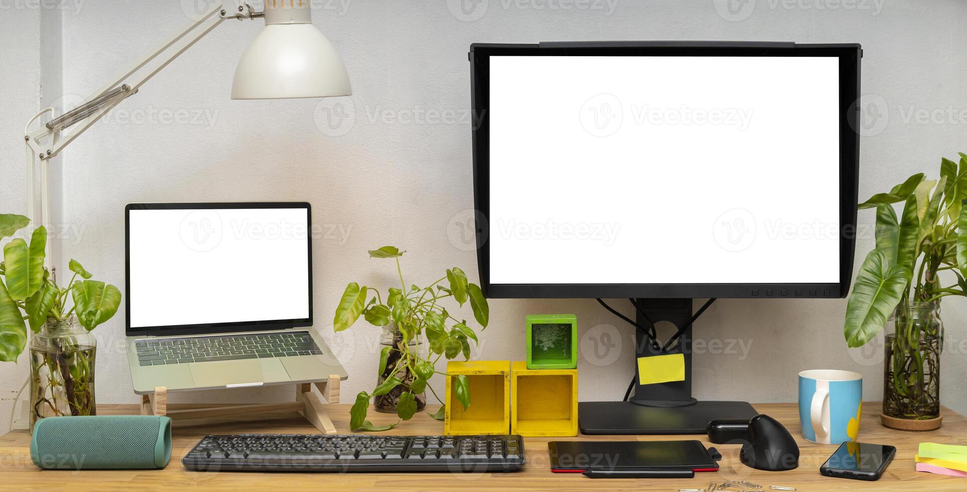 Blank white computer monitors on light wooden table with keyboard, mockup. Contemporary office and laptop photo