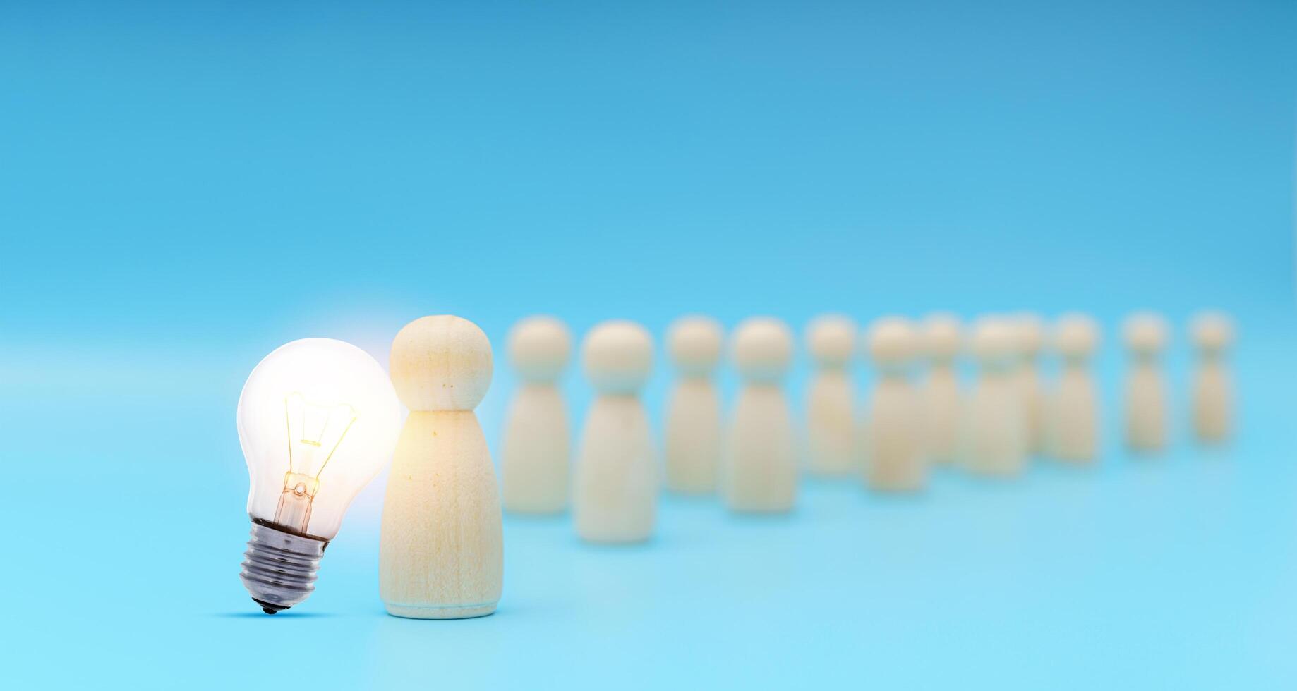 Outstanding people standing with light bulb icon out from the crowd. Human resource, Talent management photo