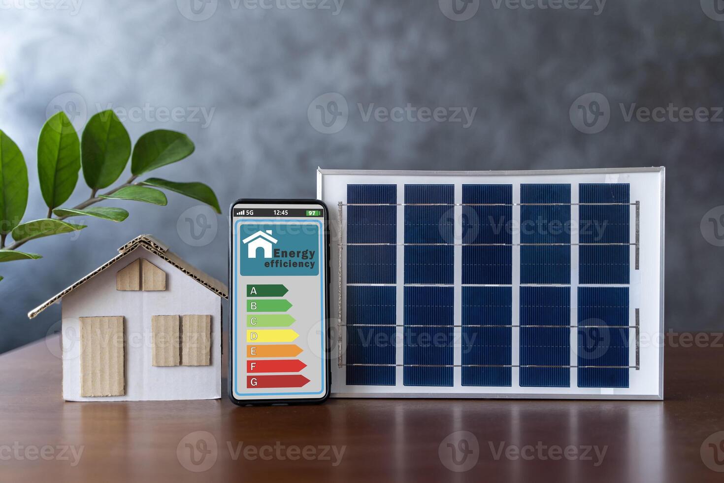Energy efficiency mobile app on screen rating with arrows and house, text. Smart home display and model house with solar panel. photo