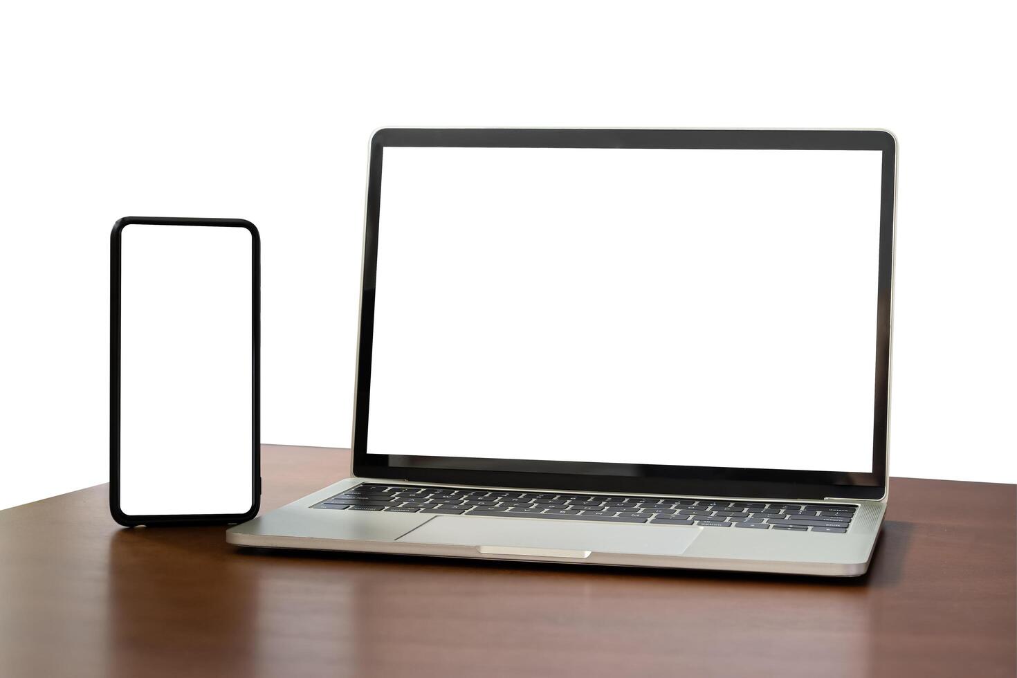 Blank screen notebook, laptop and mobile phone on isolated wooden table background with clipping path. Front view. photo