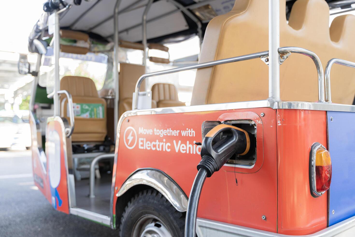 Electric car at the charging station background with free space in grey color for the site. Ecology. Eco-friendly transport. photo
