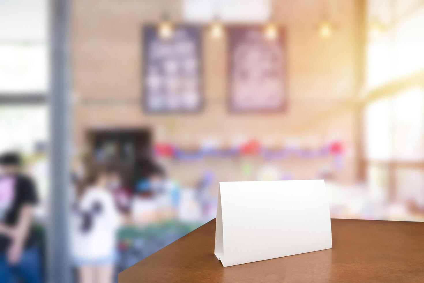 Menu frame mockup standing on wooden table in cafe restaurant bar. Space for text. Blank menu frame label mockup in restaurant bar stand. photo