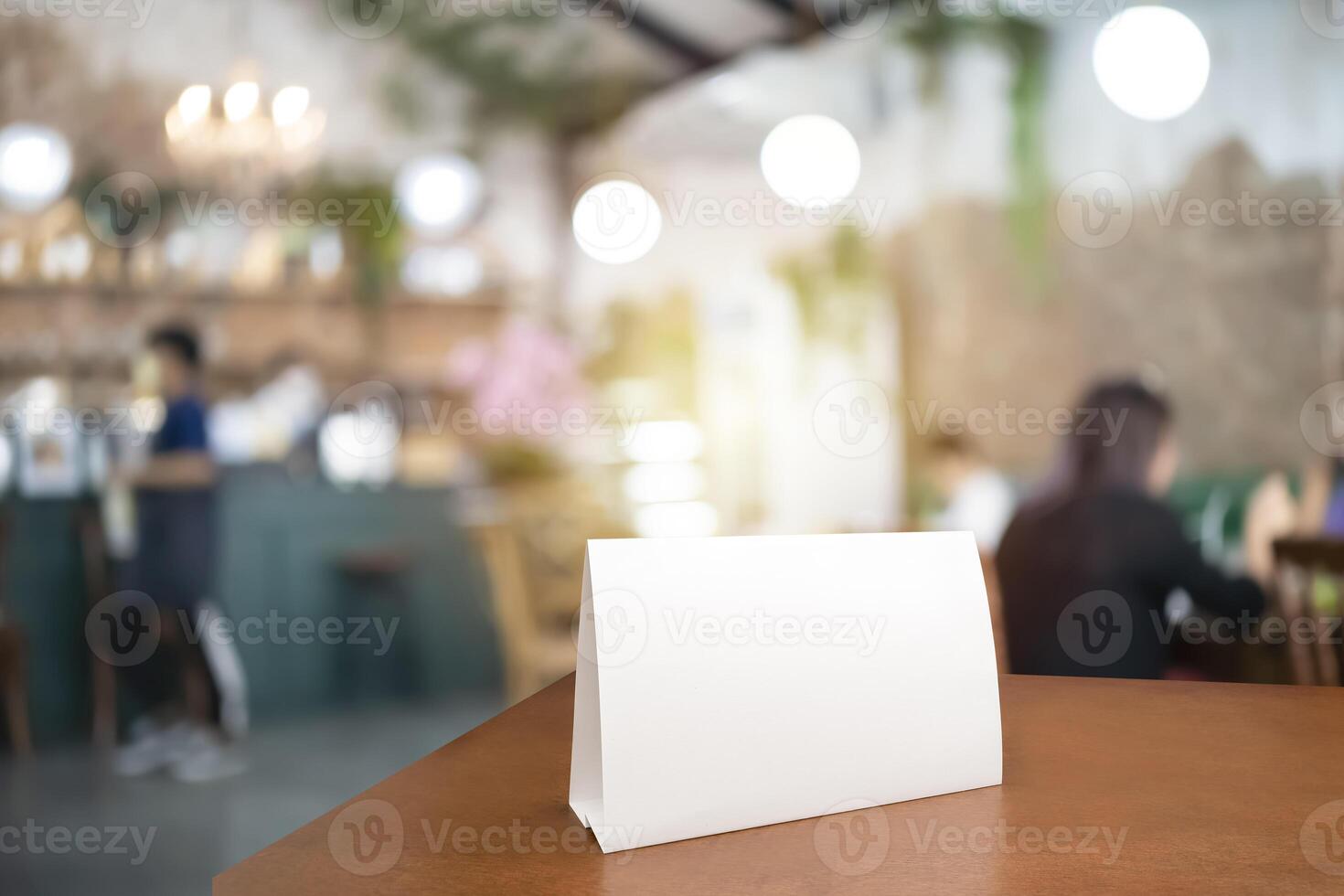 Blank menu frame label mockup. Menu frame mockup n wooden table in bar restaurant, stand for booklet with white sheet of acrylic paper tent card photo