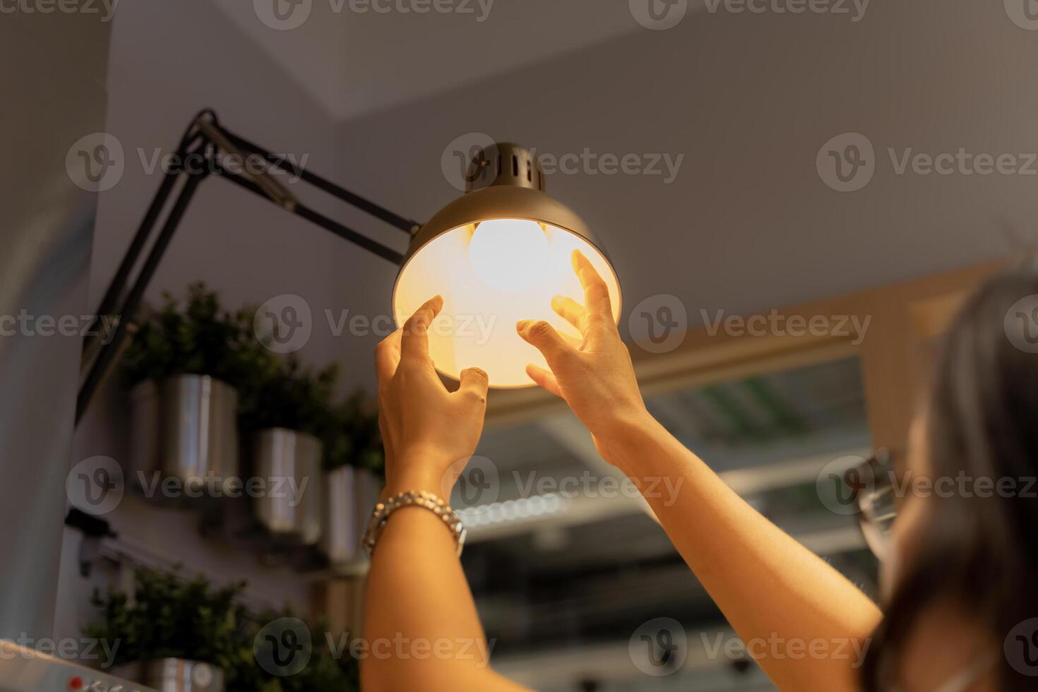 Hand woman changing with new LED lamp light bulb,Power saving concept. Reusing and recycling existing materials for future growth photo