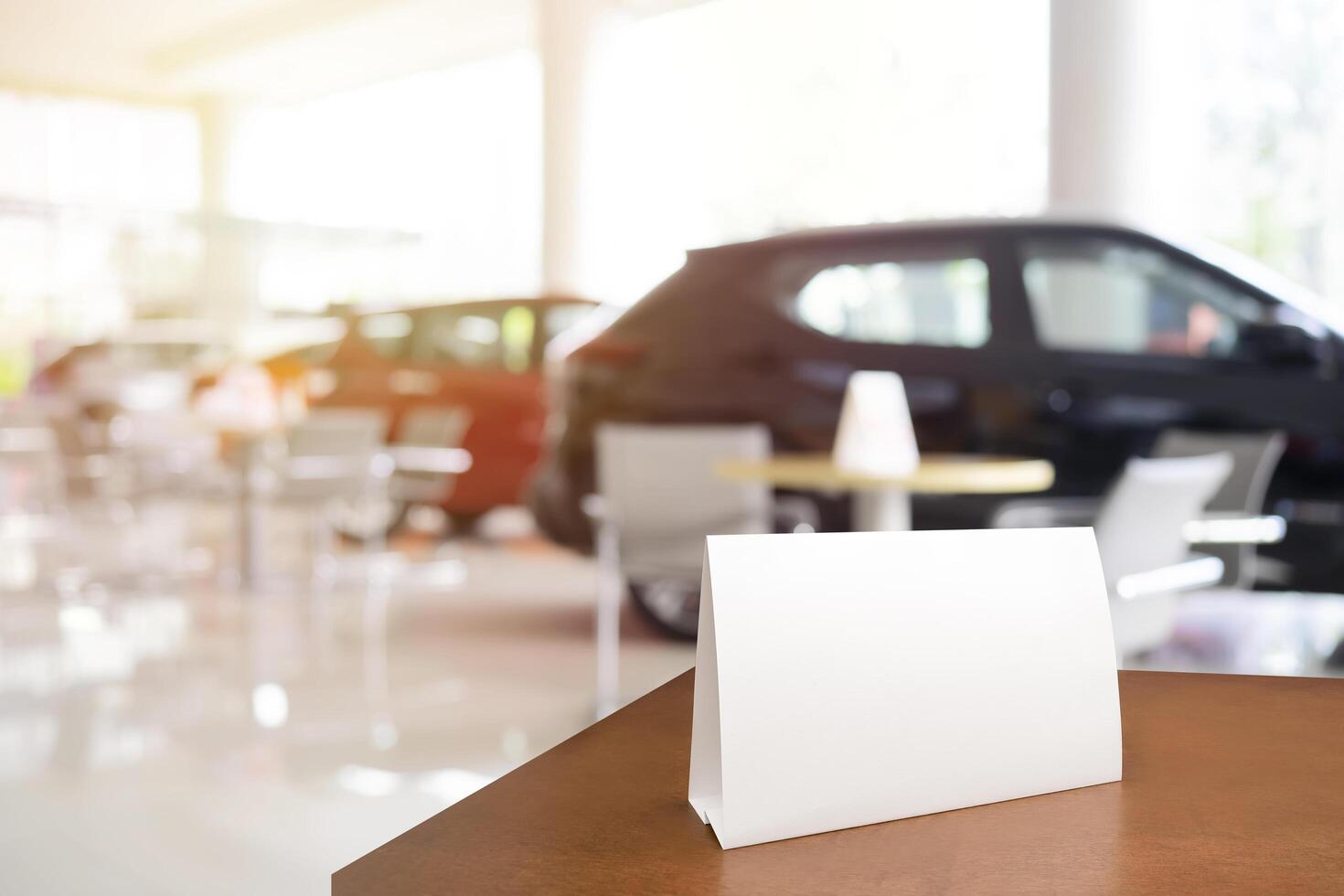 Mock up poster board stand on sales promotion advertisement sign white display on table in car show room photo