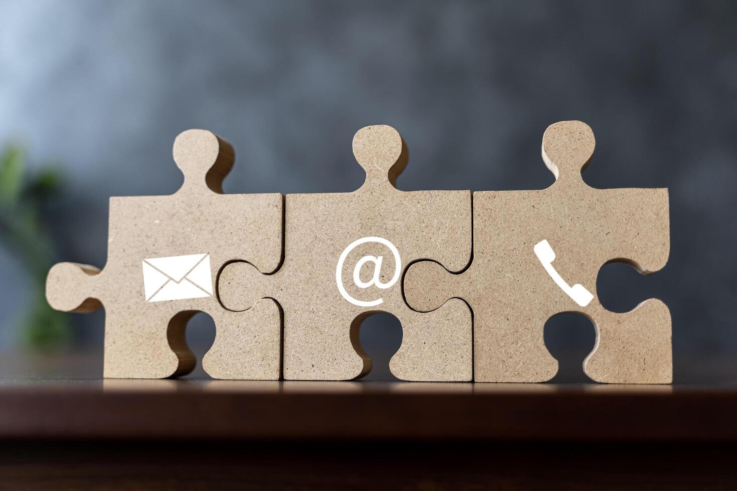Wooden jigsaw puzzle with symbol telephone, email, address. Website page contact us or e-mail marketing concept photo
