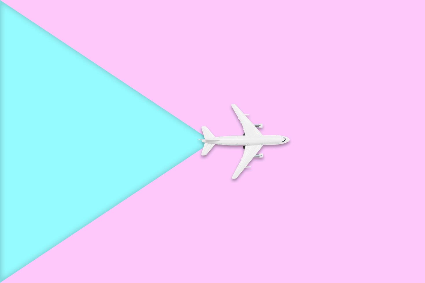 Flat lay design of travel in summer concept. Top view of an airplane on blank pink and blue pastel color screen with copy space. travel on summer trip photo