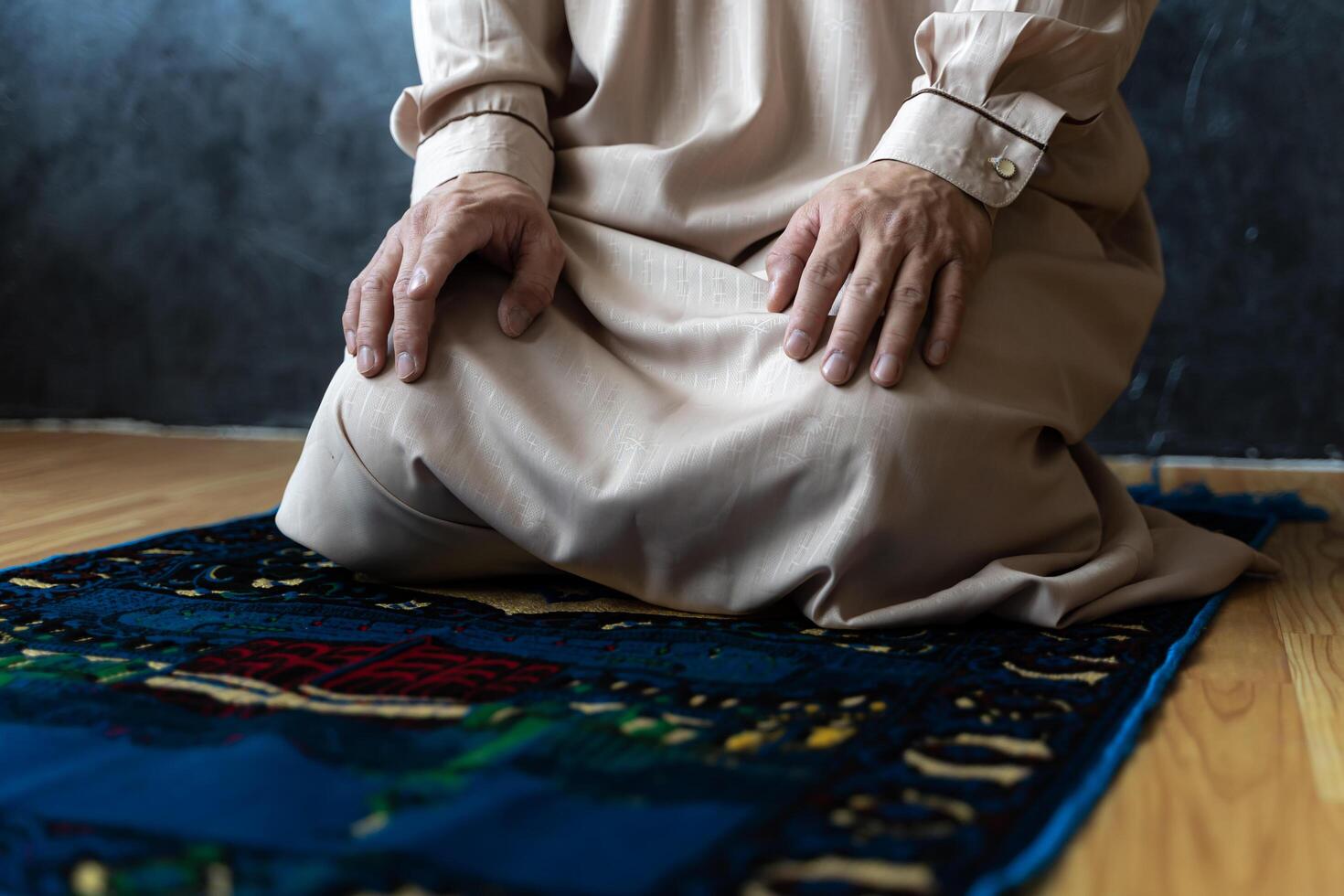 Young Asian muslim man pray on the prayer rug at home on Ramadan Kareem photo