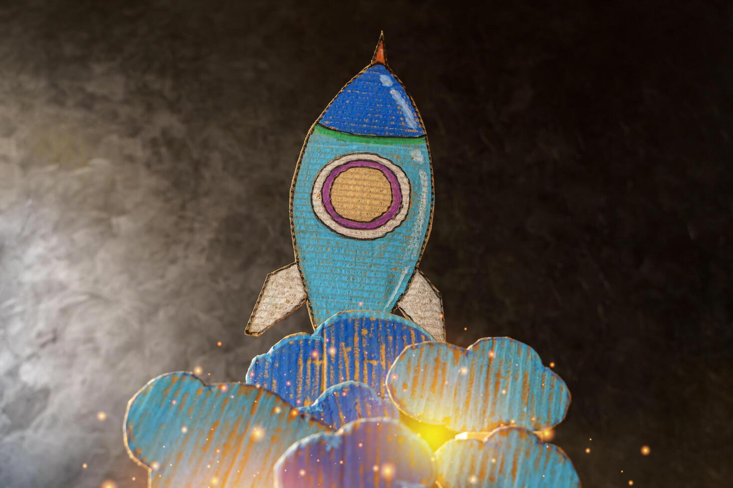 Paper clouds and rockets drawn on cardboard, success and startup concept 3d render.Startup.Rocket Sketch On Blackboard With Colorful Pencils. photo