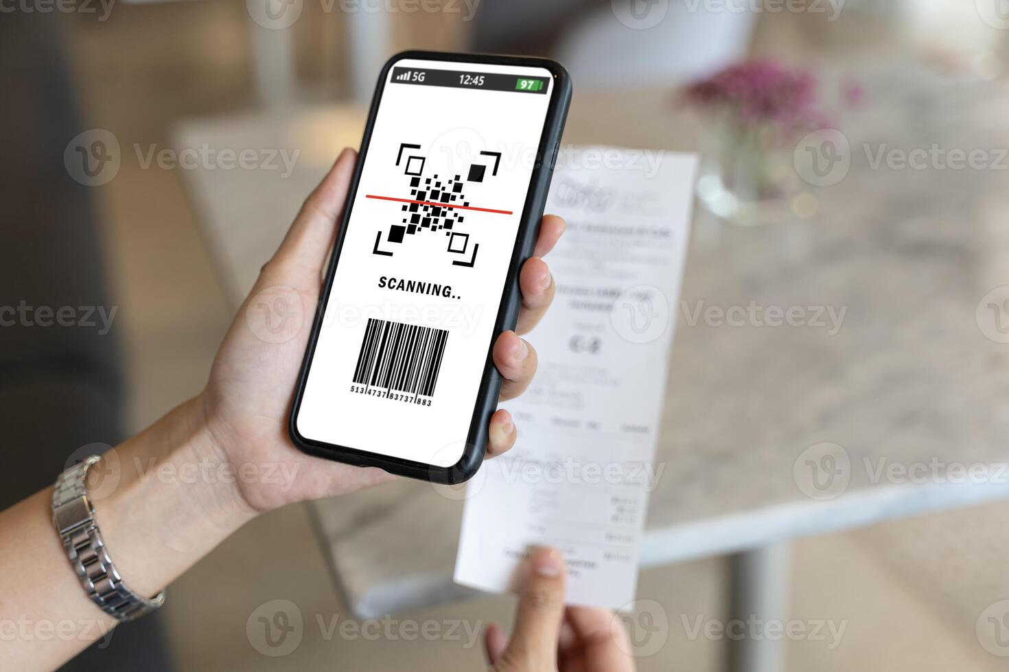 happy Asian woman paying electricity bill hand holding smart phone scanning code on paper, scan the qr code. Scan to get discounts. Using a phone to transfer money photo