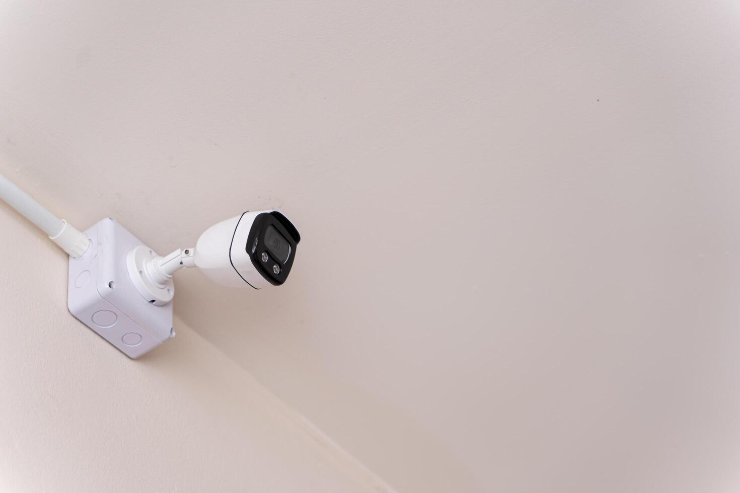 Smart CCTV camera on the wall with blue lights. Cameras work day and night, Record a in a public place. Protection from thieves photo