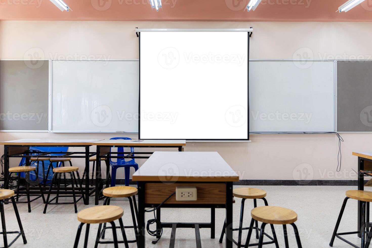 Projector screen canvas in modern conference room with big windows. Side view.Empty classroom or presentation room interior with desks photo