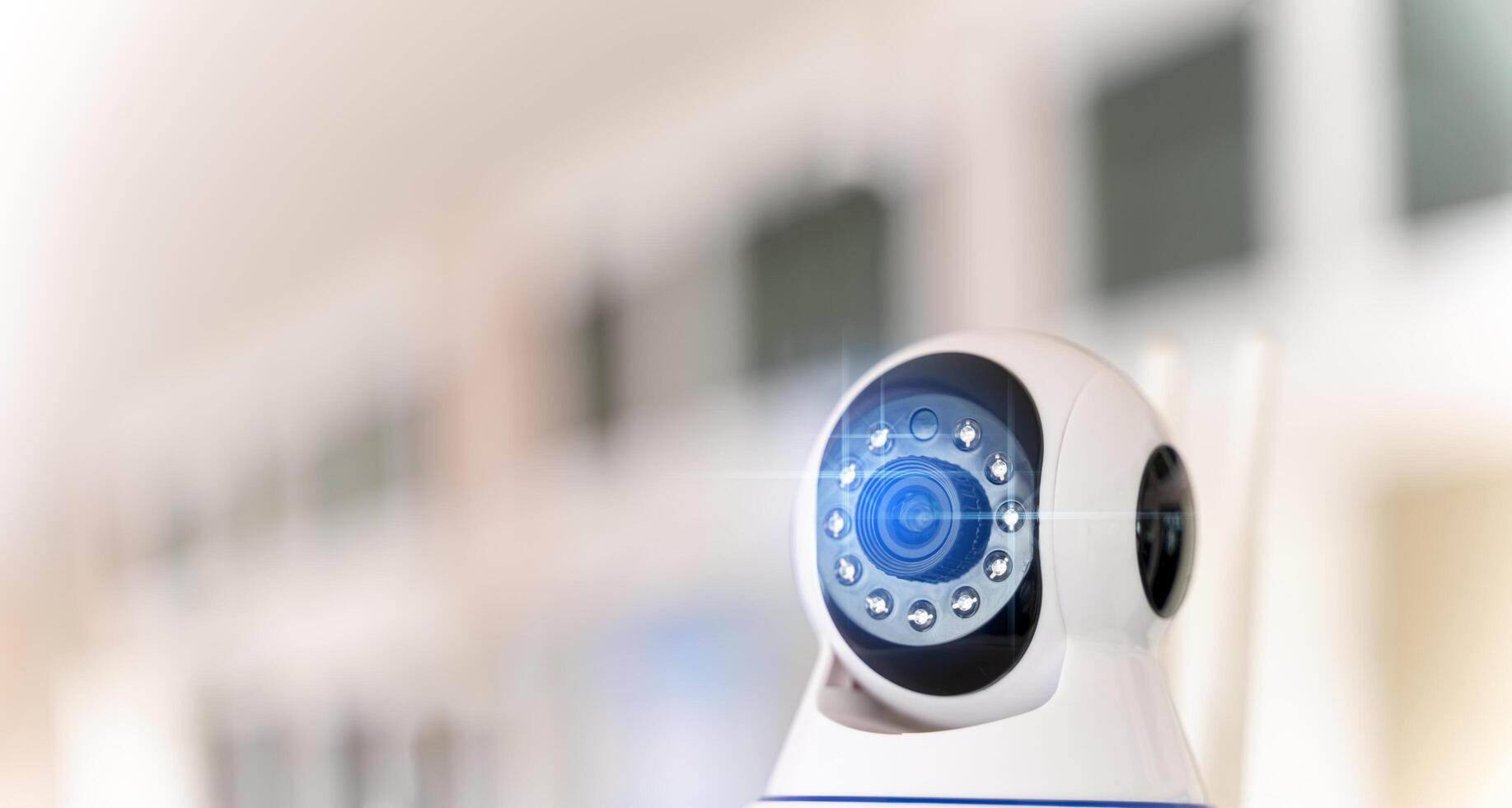 Smart CCTV camera on the wall with blue lights. Cameras work day and night, Record a in a public place. photo