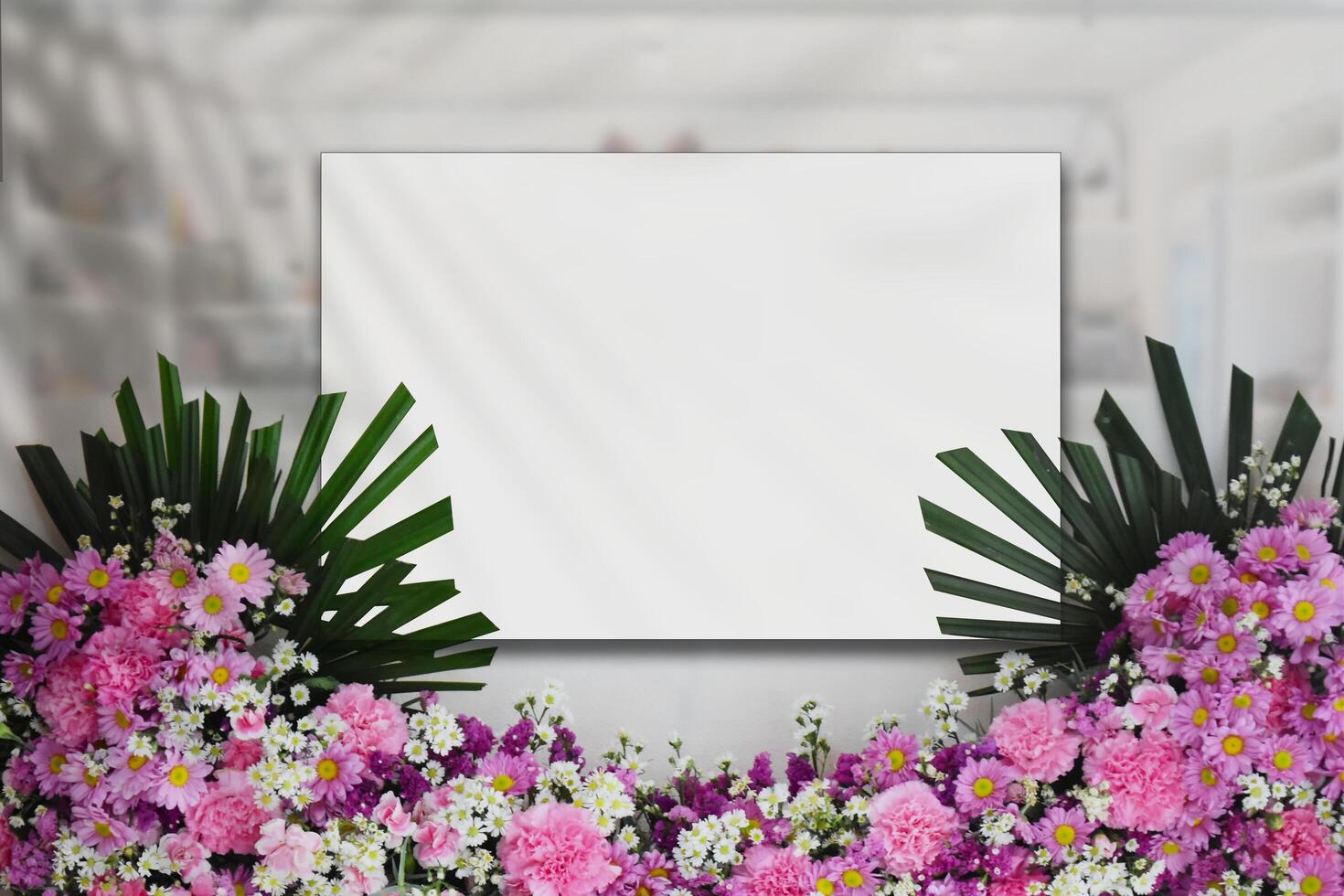A blank square sign on a glass wall, partially obscured by leaves and leaf shadows. clipping path photo
