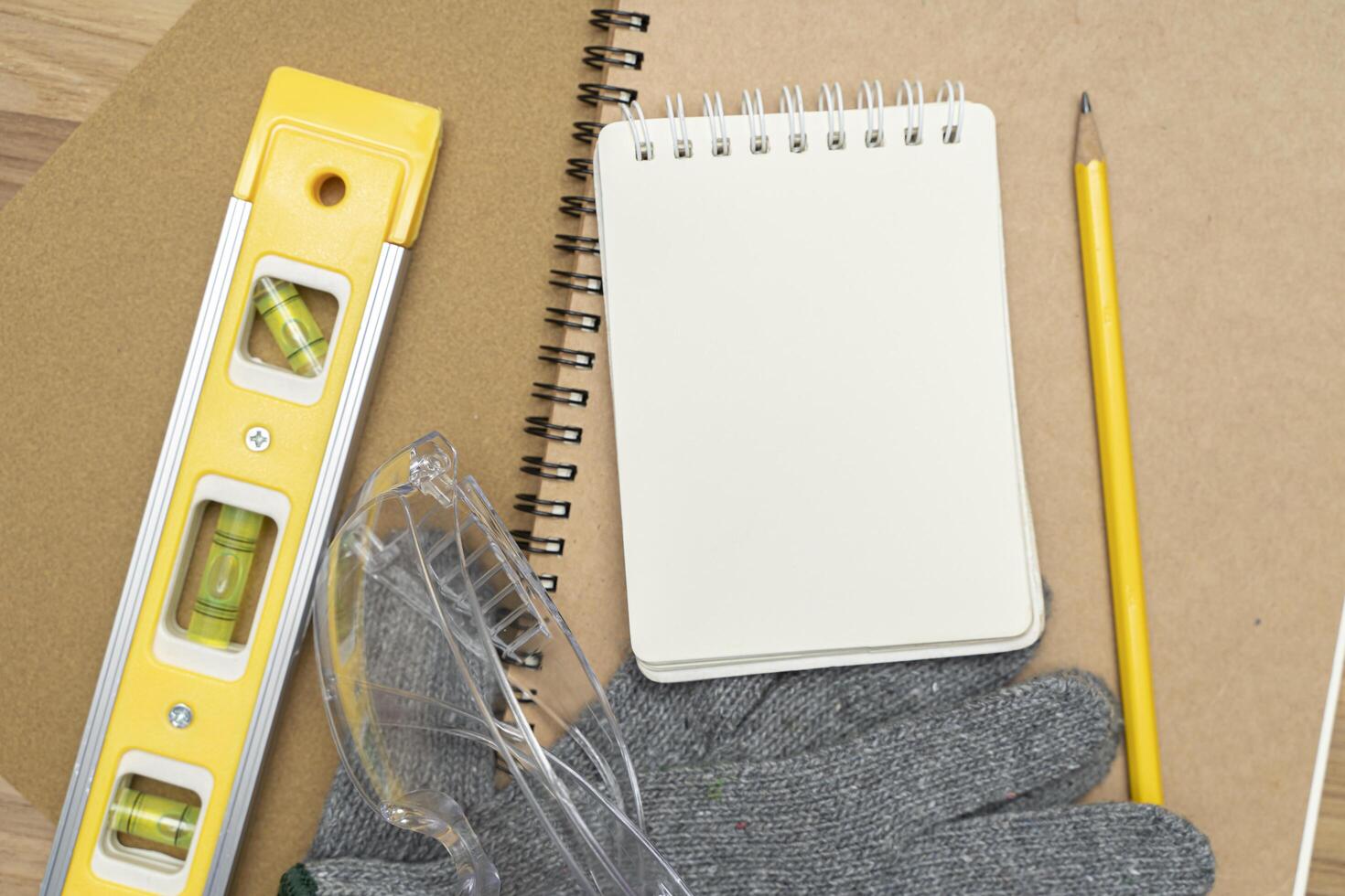 Working with woodworking, sand paper, gloves, pencil, notebook, water level photo