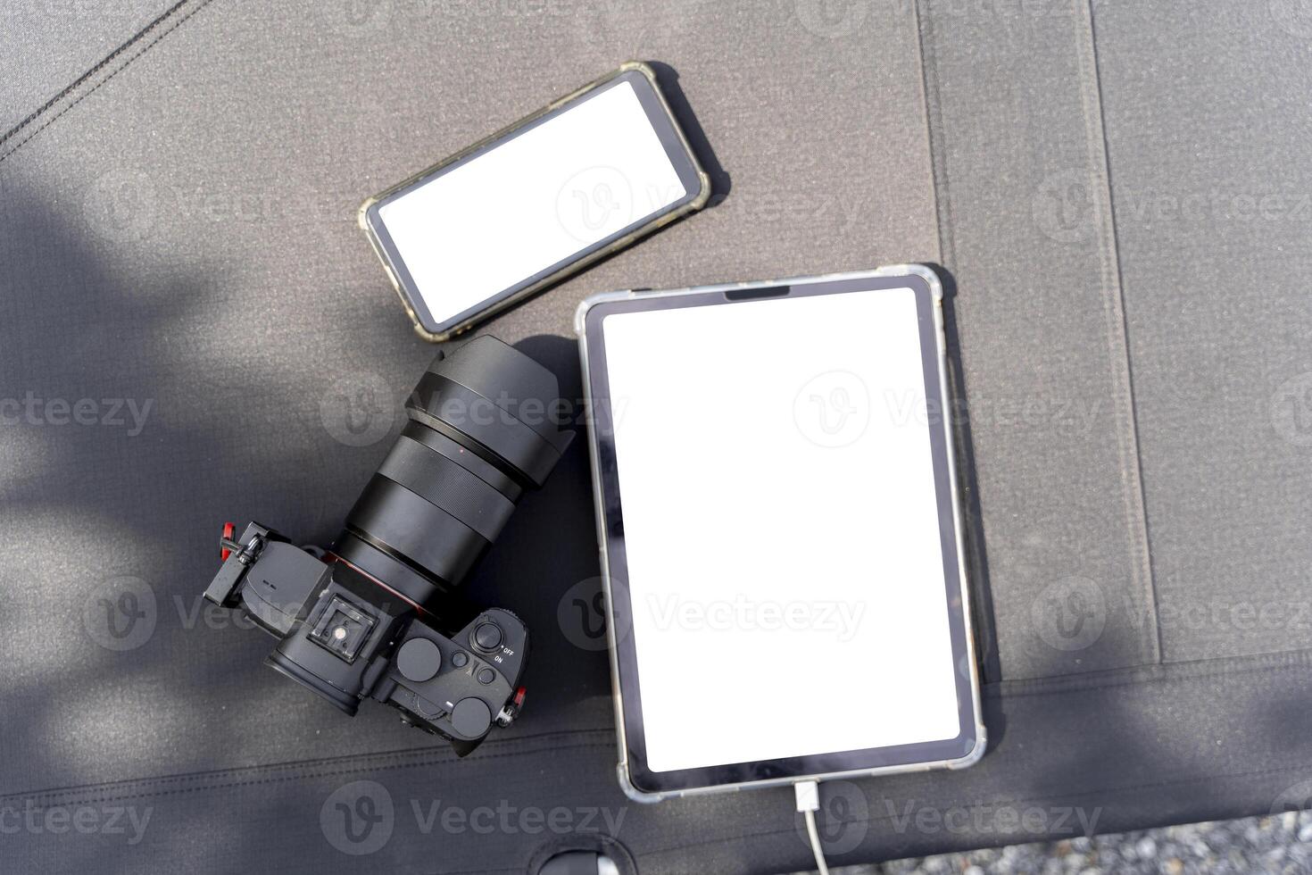 Top view of black table with smartphone, tablet, camera and copy space, include clipping path photo