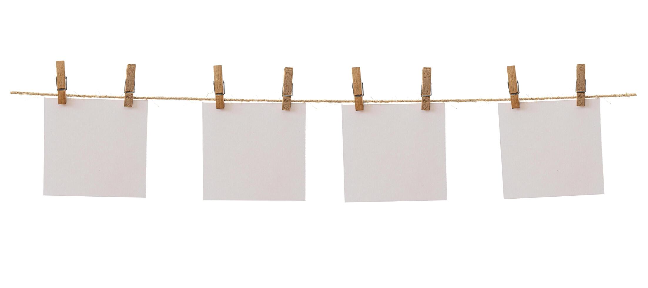 Four frames that hang on a rope with clothespins and isolated on white. Blank cards on rope mockup template, clipping path. photo