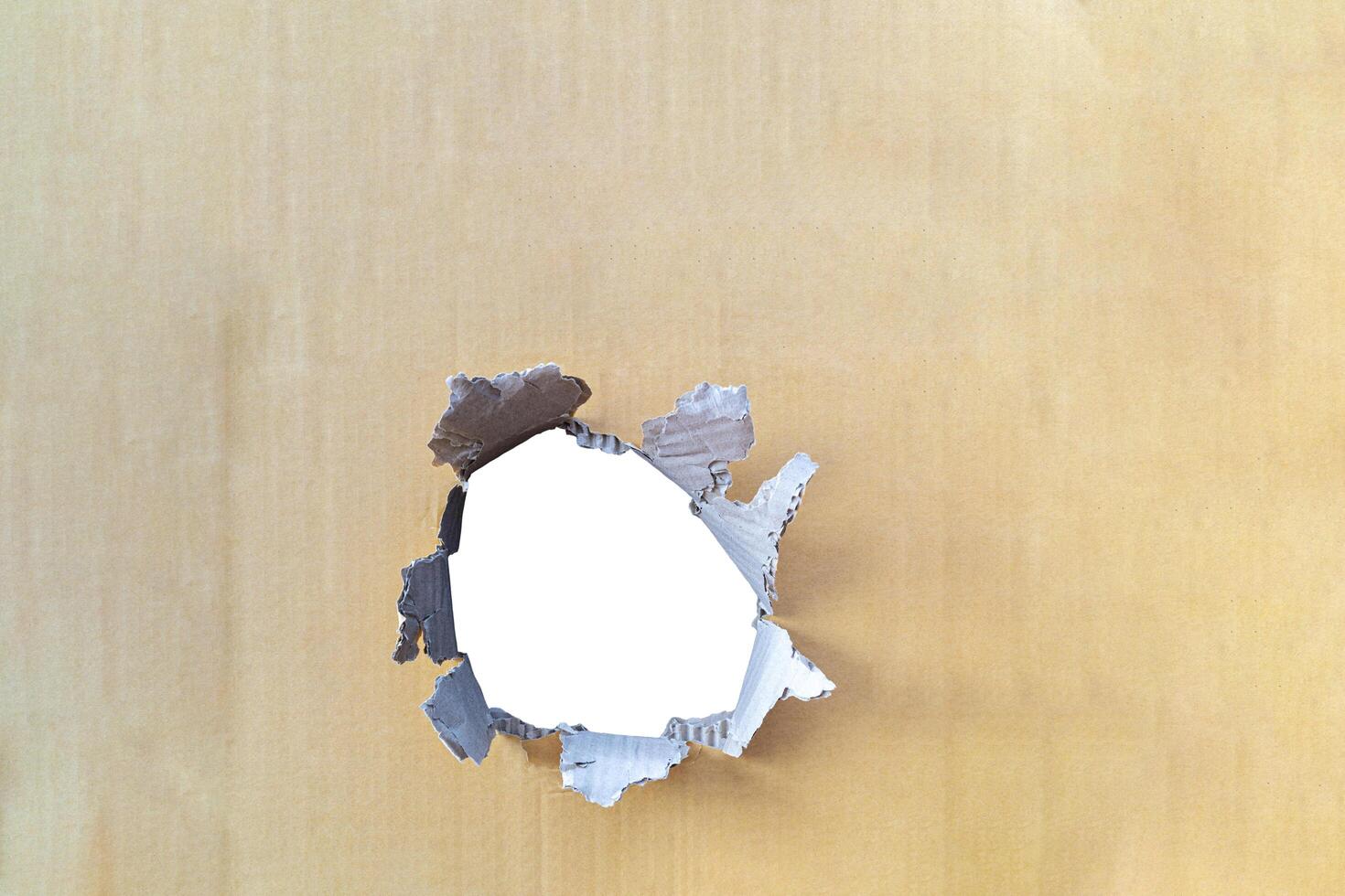 white hole in a brown cardboard background. To insert advertising photo