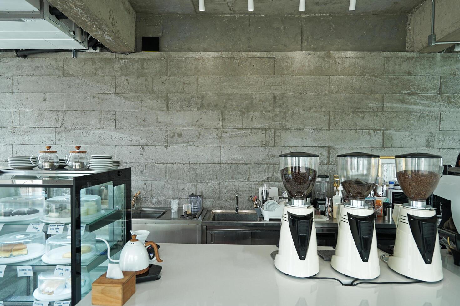 Interior design and decoration of local coffee cafe and bakery shop decorated with white furniture and concrete cement block photo