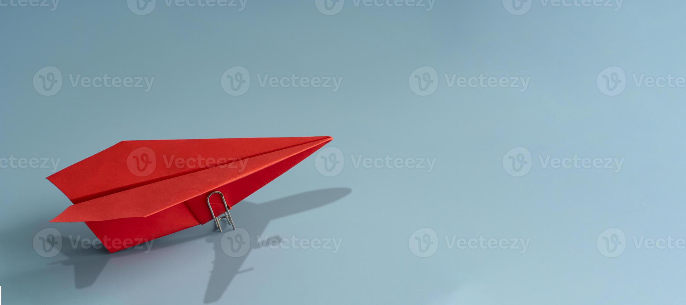 red paper plane on blue background. 3d rendering. Leadership and ambition concept, Panorama. photo