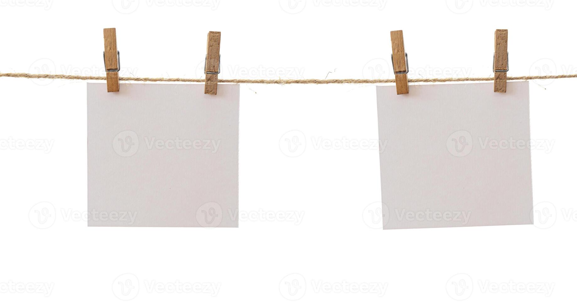 Two frames that hang on a rope with clothespins and isolated on white. Blank cards on rope mockup template, clipping path. photo