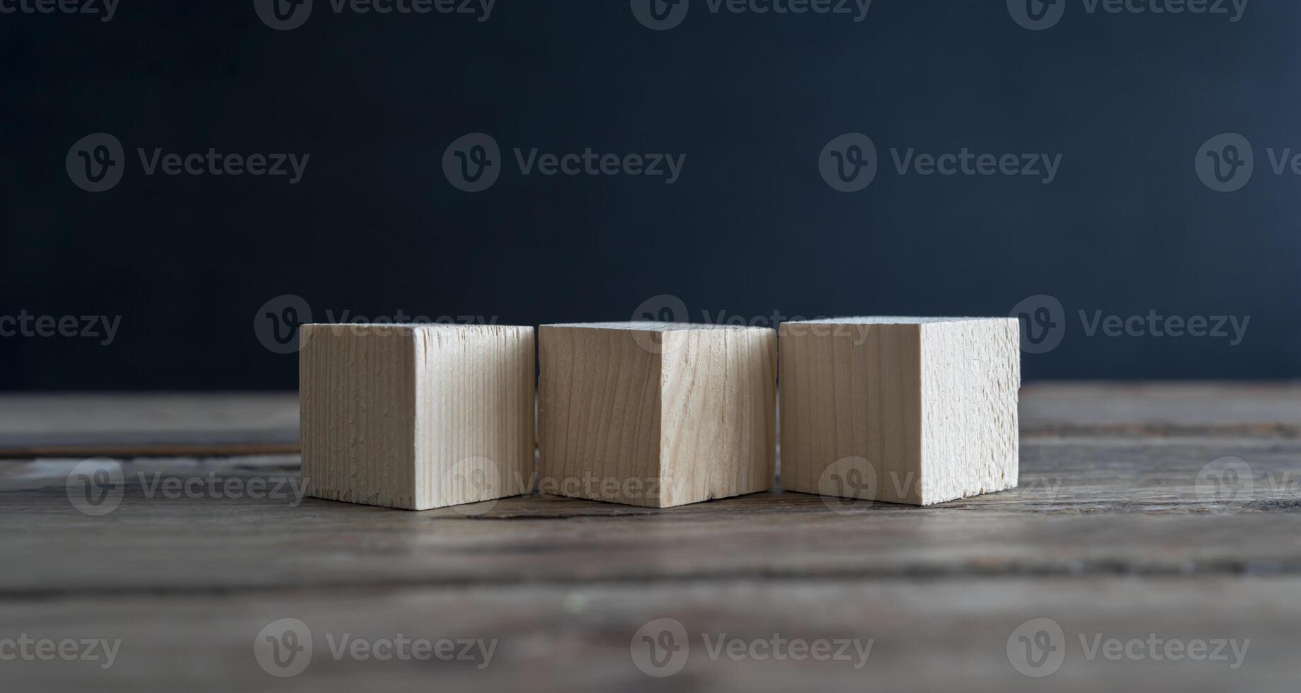 Blank wooden cube blocks on the table. Three pieces are placed side by side, six sides photo